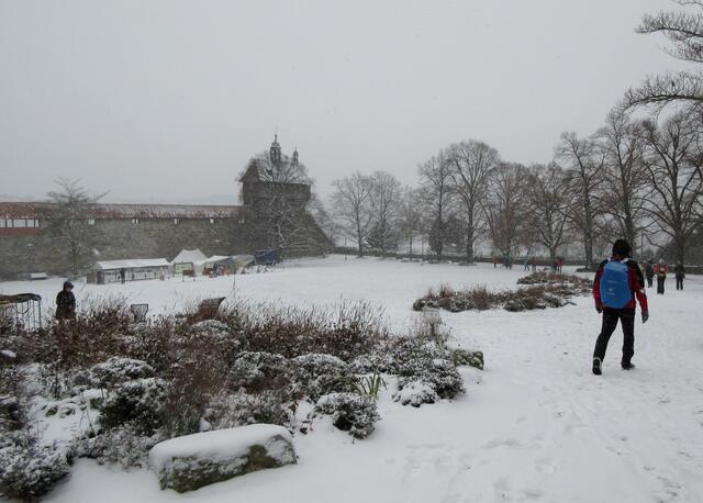 Links im Bild kommt der Seilergang vom Dicken Turm in Richtung Hochwacht. Dort strebt die Gruppe hin zum Einstieg in die Burgstaffel. Davor wird das heutige Bogenschießturnier vorbereitet.