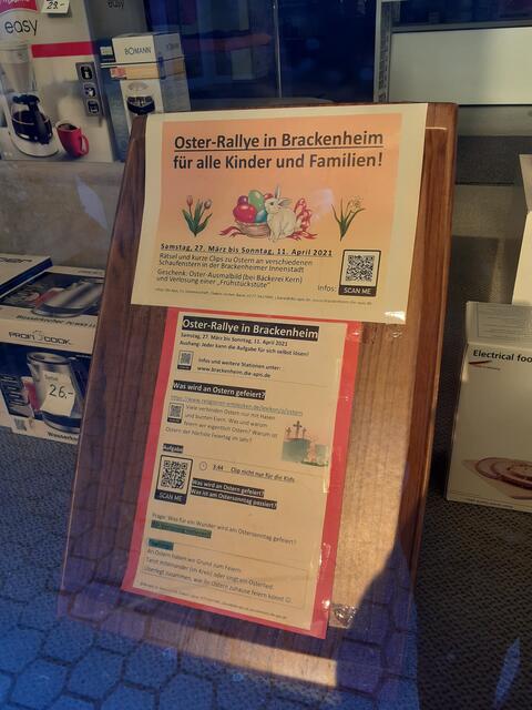 Aushang der Oster-Rallye im Schaufenster des Elektro-Laden "Laur" gegenüber der Baustelle vom Schloss Brackenheim.