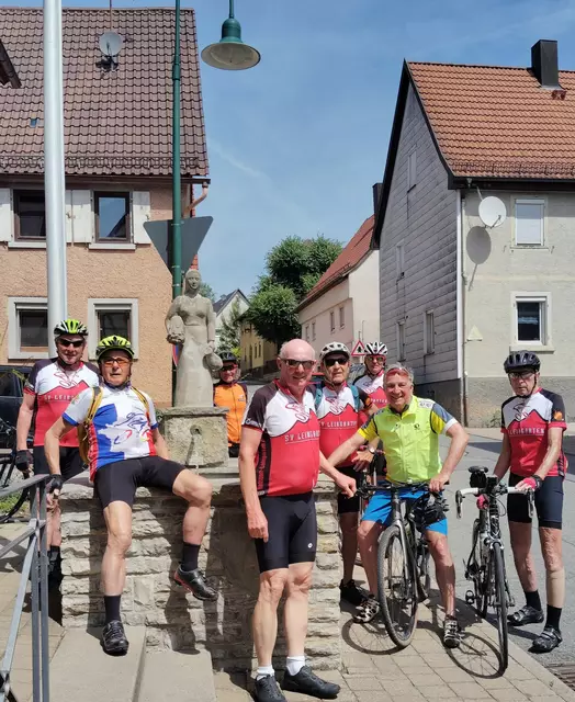 SV Leingarten Radsportler vor dem Dorfbrunnen mit Brunnenfigur 
in Hüffenhardt | Foto: Urheberbild von Willi Frasch
